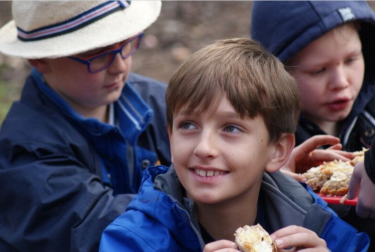 Campers enjoying damper they cooked over the campfire