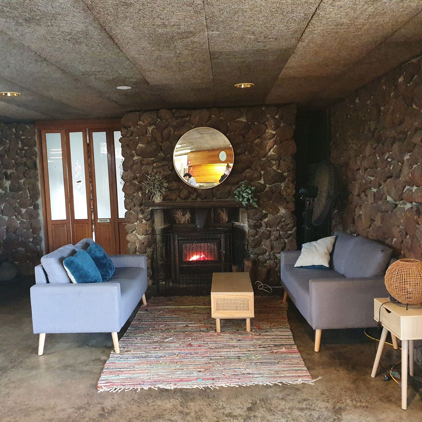 The homestead lounge with its stone fireplace lit