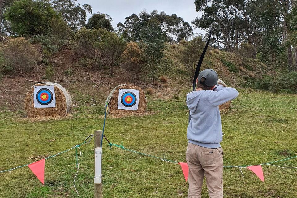 An adult shooting at the archery range