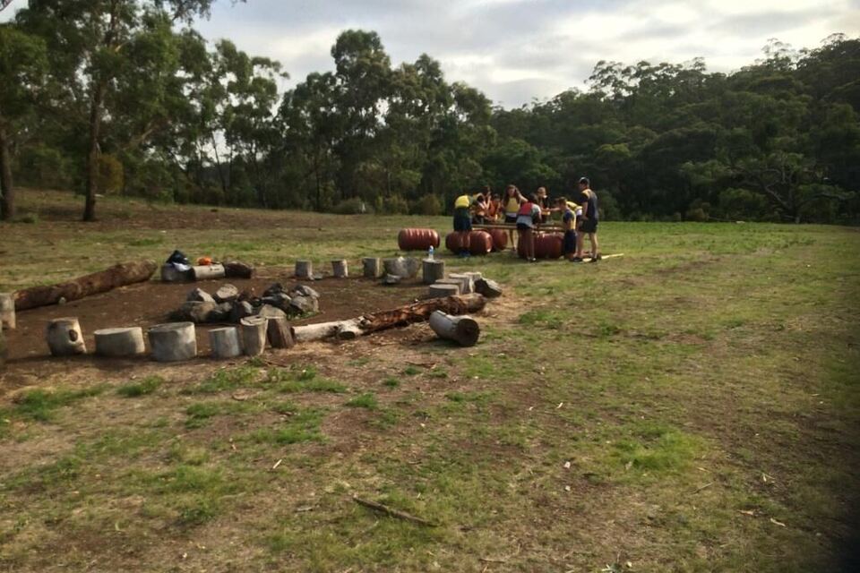 A group gathered around the fire circle