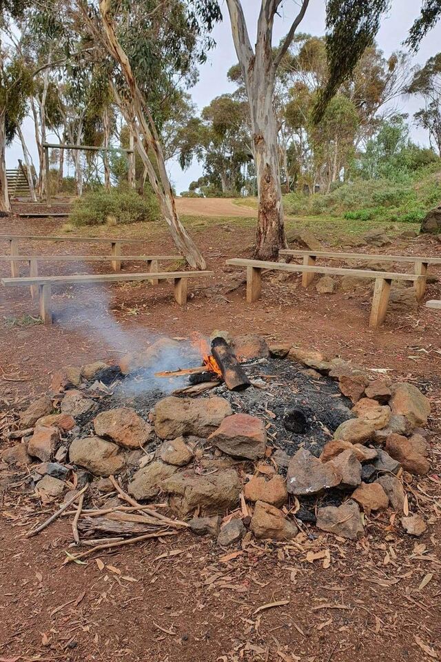 The campfire circle with fire crackling