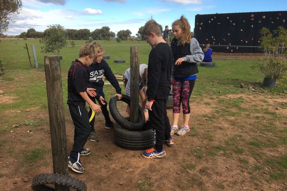 Students solving an initiatives challenge with tyres