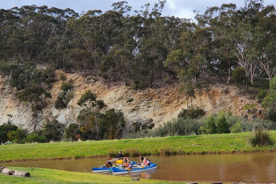 Canoes beneath the white cliffs on the dam