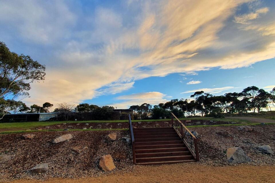 The homestead stairs under a sunset sky