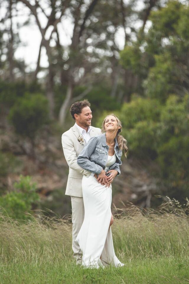 A couple smiling among the trees