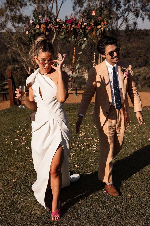 A stylish couple walking and laughing on the lawn