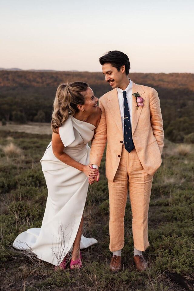 Newlyweds laughing together in the golden light