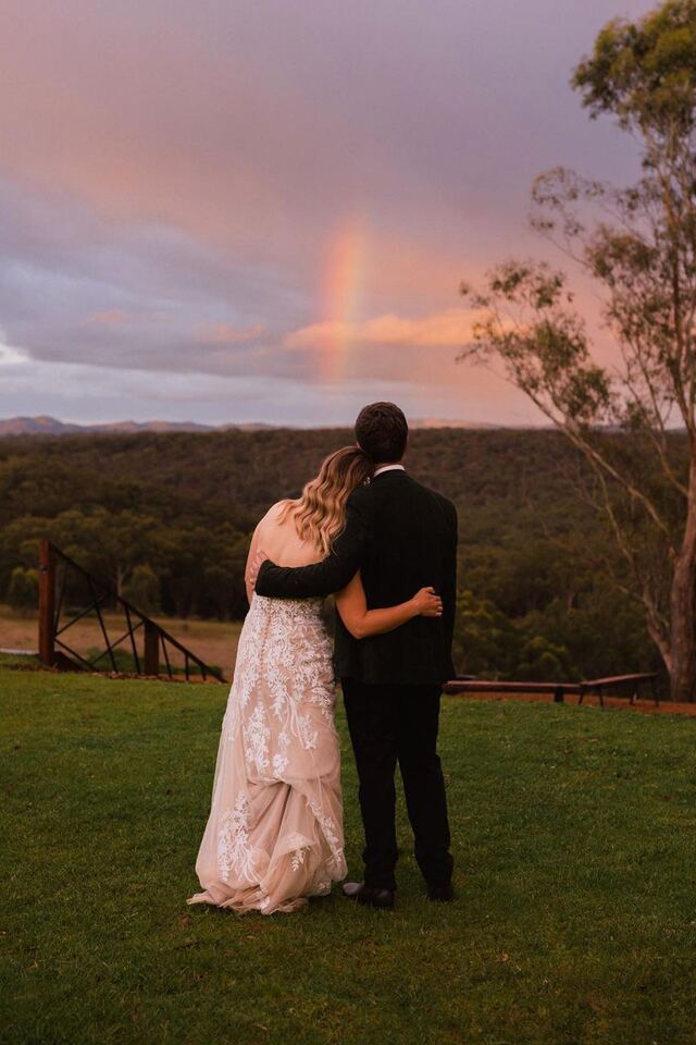 A couple watching the sunset over the ranges