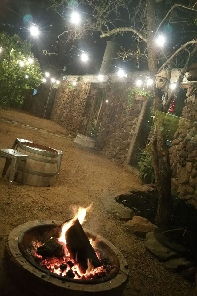 The stone courtyard glowing with festoon lights at night