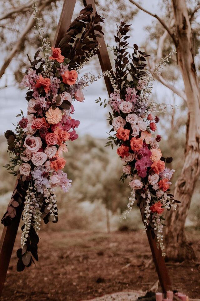 Close-up of a pink floral ceremony arch