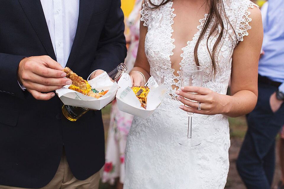 The newlyweds enjoying food truck snacks
