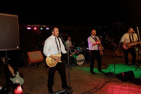 A live band performing for guests on the dance floor at night