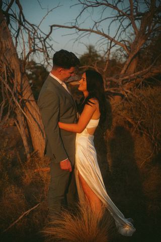 A couple sharing a quiet embrace among the bushland