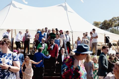 Guests mingling under the marquee during the daytime reception