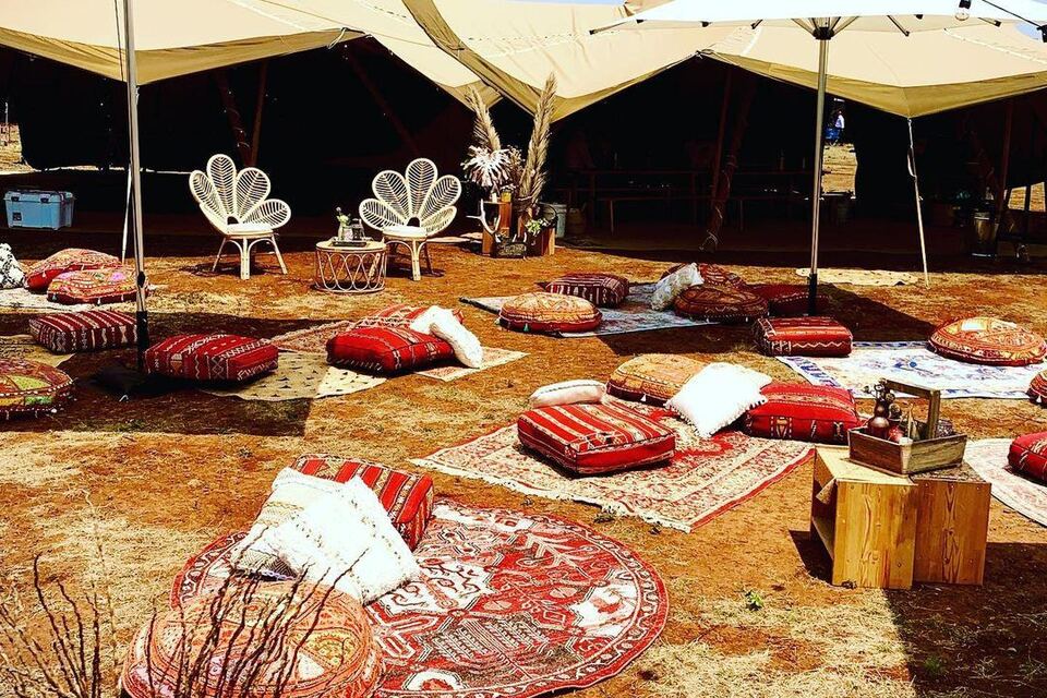 Bohemian tipi lounge styled with rugs and cushions